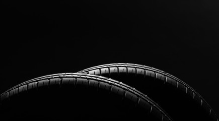 Studio shot of a set of summer, fuel efficient car tires on black background. Contrasty lighting and shallow depth of field