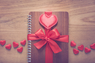 notebook wrapped with red ribbon, red felt hearts with Made With