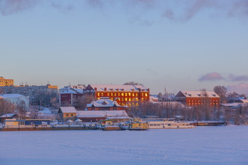 Fototapeta na wymiar old houses in the light of dusk in winter city