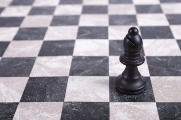 black wooden bishop on chessboard