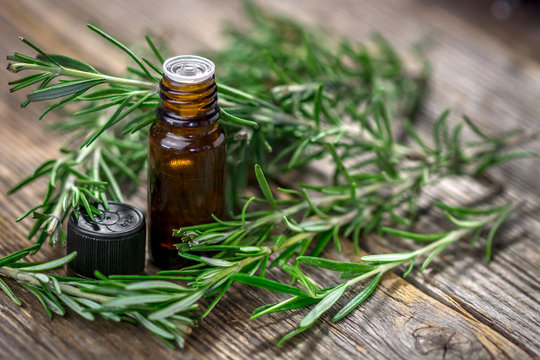 Rosemary essential oil and fresh rosemary