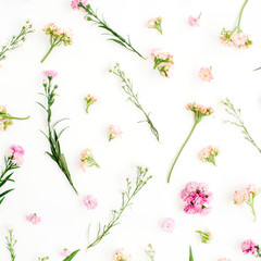 Floral pattern with pink and beige wildflowers, green leaves, branches on white background. Flat lay, top view. Valentine's background