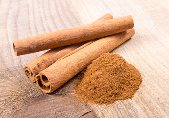 Cinnamon sticks on wooden background.