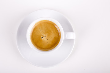 top view of white cup full with delicious coffee with crema