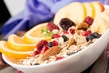 Healthy breakfast. Muesli with orange fruit, apple, pomegranate,
