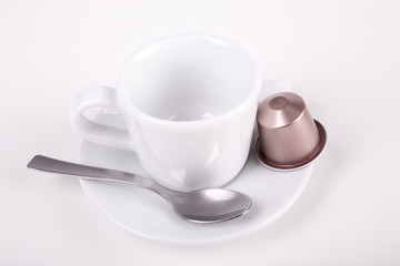 coffee cup with capsule and spoon