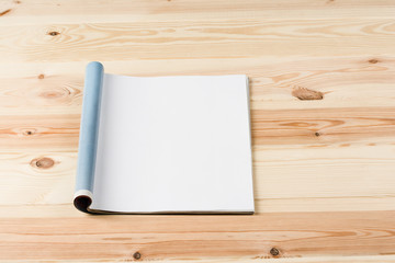 Mock-up magazine or catalog on wooden table. Blank page or notepad on wood background. Blank page or notepad for mockups or simulations.