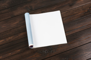 Mock-up magazine or catalog on wooden table. Blank page or notepad on wood background. Blank page or notepad for mockups or simulations.