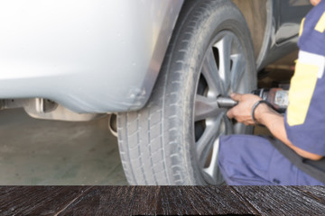 Auto mechanic in his workshop changing tires or rims (blur image