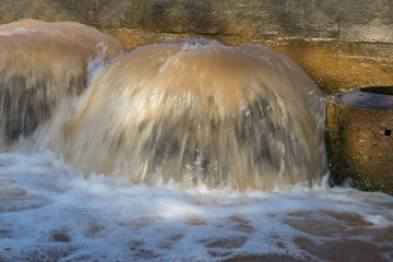 Close-stop stream overflowing sewer severe foaming in the concrete canal, one of Thailand.
