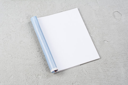 Mock-up magazine or catalog on concrete. Blank page or notepad on construction background. Blank page or notepad for mockups or simulations.