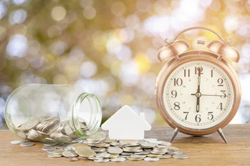 retro alarm clock with thai coin on wood background