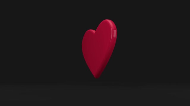 Rotating and floating heart on black background