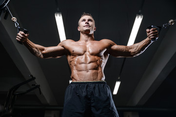 Fototapeta na wymiar Handsome fitness model train in the gym gain muscle