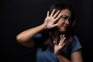 Sad woman on isolated black background