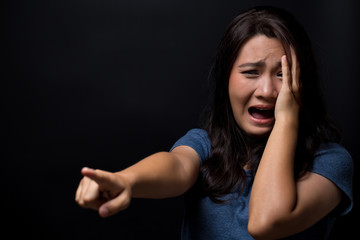 Scared woman on isolated black background