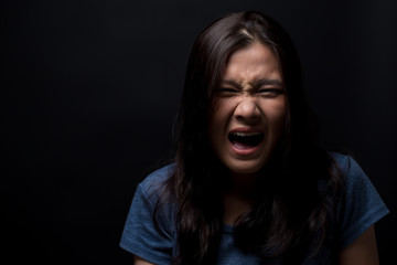 Screaming woman on black background