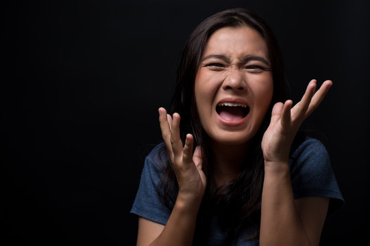 Screaming woman on black background