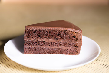 Delicious dark chocolate cake in white plate