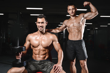 Fototapeta na wymiar two young men train in gym healthcare lifestyle sexy caucasian.