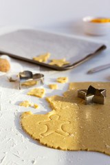 Rolled out Sweet Biscuit Dough with Festive Cookie Cutters on White Table