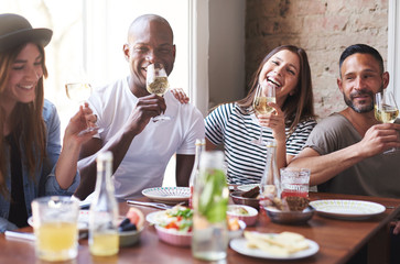 Young people drinking and looking at camera