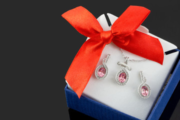 Silver jewelry set on a box in black background. / jewelry pendant, gems,diamonds,crystal,  ruby,...