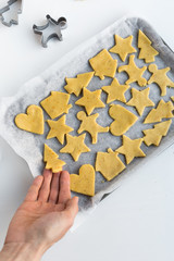 Overhead View of Sweet Biscuit Dough Cut into Festive Christmas Shapes on Baking Tray