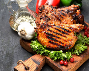 fried pork steak, lettuce on a cutting board