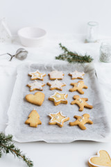 Vertical Food Scene of Festive Christmas Biscuits lined up on Baking Tray