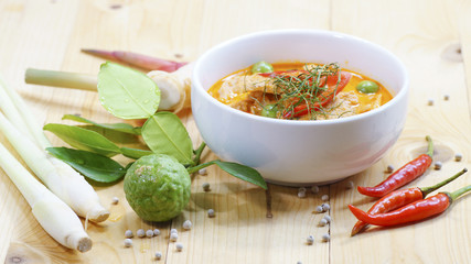 Panaeng curry with pork with spices, chili, lemon grass,bergamot leaf on wood
