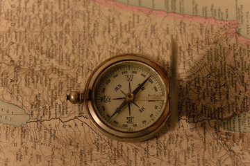 Old compass on the background of old maps