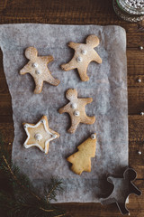 Baked Gingerbread Men, Star and Christmas Tree Biscuits on Parchment Paper