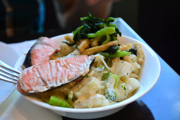 Smoked salmon with wasabi and vegetables on a bowl. Japanese food.