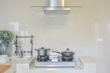 stainless pan on gas stove with utensil in modern kitchen