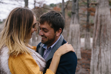 Fototapeta premium happy couple outdoor. hugging and kissing man and woman in park
