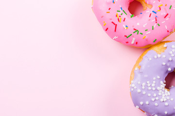 Pink round donut on pastele background. Flat lay, top view.