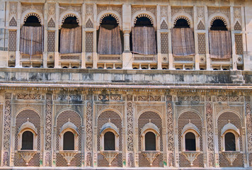 Fototapeta na wymiar Rows of nineteenth century windows in Gujarat, India 