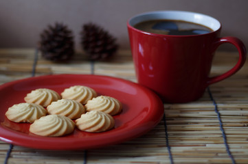 Hot coffee and homemade cookies on wooden background.