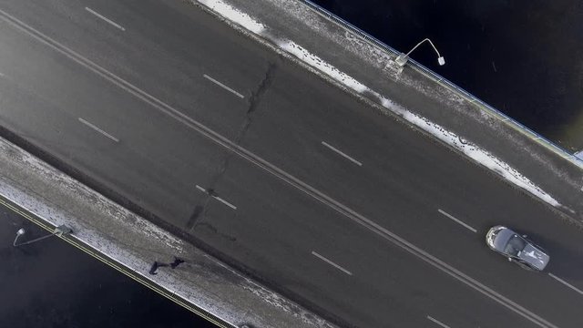 Traffic on the bridge, shoot from the air, it's snowing. 4k video