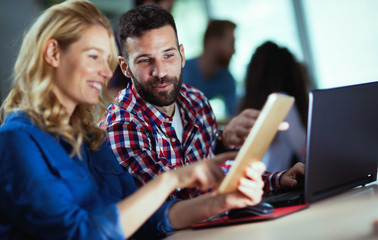 Programmers cooperating at information technology company