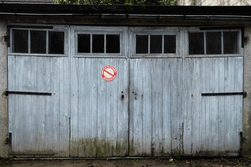 Garage with weathered white doors