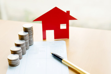 money, coins stack in columns with saving book and paper home,co