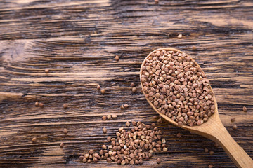 raw buckwheat in a wooden spoon