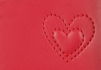 embroidery in shape of two hearts on pink leather