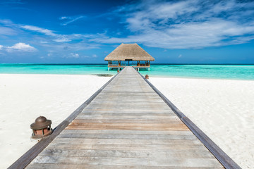 Wooden jetty leading to relaxation lodge. Maldives islands