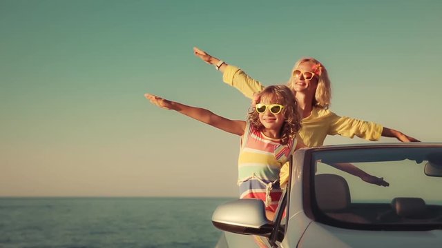 Happy family travel by car on summer vacation. Slow motion