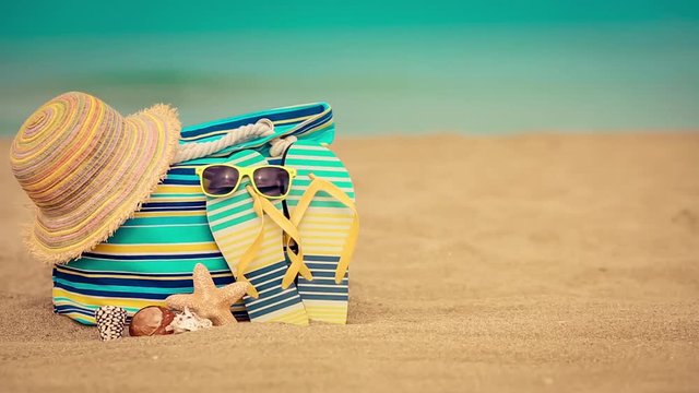 Beach bag on sand. Summer vacation and travel concept