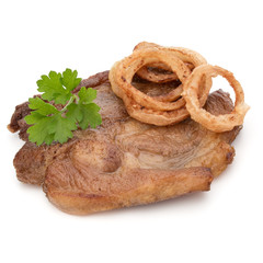 Cooked fried pork meat with parsley herb leaves and onion slices