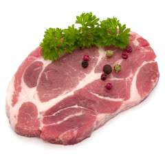 Raw pork neck chop meat with parsley herb leaves and peppercorn